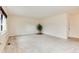 Bright living room features neutral carpet, white walls, and a potted plant adding a touch of nature at 3150 S Pitkin St, Aurora, CO 80013