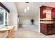 Bright living room with neutral carpet, white walls, wooden cabinets, and pendant lighting over the breakfast bar at 3150 S Pitkin St, Aurora, CO 80013