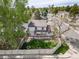 Aerial view of a fenced backyard with patio, pergola, fire pit, lawn, mature trees, and surrounding neighborhood at 6398 S Emporia Cir, Englewood, CO 80111