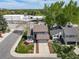 Overhead shot of a house with an attached garage, pretty landscaping, and a cozy outdoor seating area at 6398 S Emporia Cir, Englewood, CO 80111