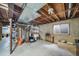 Unfinished basement with exposed ceiling, concrete floor, and small window allowing for natural light at 6398 S Emporia Cir, Englewood, CO 80111