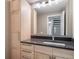 Bathroom features a gray counter, chrome hardware, and a blonde wood vanity and storage cabinet at 6398 S Emporia Cir, Englewood, CO 80111