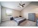 Bedroom with gray carpet, a ceiling fan, window with blinds, a bed and dark blue shelving at 6398 S Emporia Cir, Englewood, CO 80111