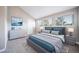 Bedroom with vaulted ceilings, a gray platform bed, large windows, and a gray dresser at 6398 S Emporia Cir, Englewood, CO 80111