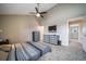 Bedroom with gray carpet and ceiling fan offers ample natural light, along with blue shelving at 6398 S Emporia Cir, Englewood, CO 80111