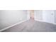 Empty bedroom featuring neutral walls and carpet, enhanced by a doorway leading to the upstairs hallway at 6398 S Emporia Cir, Englewood, CO 80111