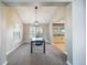 Inviting dining area featuring a modern chandelier and a view into the kitchen at 6398 S Emporia Cir, Englewood, CO 80111