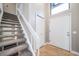 Bright foyer featuring a carpeted staircase, high ceilings, and neutral paint colors at 6398 S Emporia Cir, Englewood, CO 80111