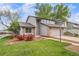 A quaint two-story house boasting a tidy front lawn, brick details, and a convenient two-car garage at 6398 S Emporia Cir, Englewood, CO 80111