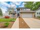 Charming two-story home featuring brick accents, a two-car garage, and a well-maintained front yard at 6398 S Emporia Cir, Englewood, CO 80111