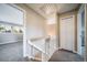 Hallway features carpeted floors, a staircase with white banister, and access to several rooms at 6398 S Emporia Cir, Englewood, CO 80111