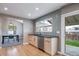 Bright and airy kitchen featuring stainless steel appliances, wooden cabinets, and access to dining area at 6398 S Emporia Cir, Englewood, CO 80111