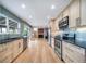 Modern kitchen with stainless steel appliances and a view into the living room with fireplace at 6398 S Emporia Cir, Englewood, CO 80111