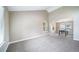 Bright living room with large windows and neutral walls, leading to a dining area at 6398 S Emporia Cir, Englewood, CO 80111