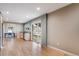 Bright open-concept living room featuring hardwood floors, a kitchen, dining area, and sliding glass doors to a patio at 6398 S Emporia Cir, Englewood, CO 80111