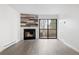 Bright living room with a modern fireplace and sliding glass door to balcony, creating a cozy and inviting space at 14720 E Kentucky Dr # 622, Aurora, CO 80012