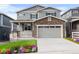Beautiful two-story home with stone accents, a covered porch, and a two-car garage at 2171 Peralta Loop, Castle Rock, CO 80104