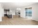 Open-concept living room with fireplace, light hardwood floors, and a sliding glass door leading to an outdoor space at 2171 Peralta Loop, Castle Rock, CO 80104