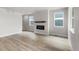 Spacious living room featuring a fireplace, light wood floors, and plenty of natural light at 2171 Peralta Loop, Castle Rock, CO 80104