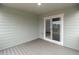 View of the covered patio with wood-look decking and sliding glass doors at 2171 Peralta Loop, Castle Rock, CO 80104