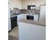 This is a vintage kitchen with all white cabinets, black hardware, and black appliances at 1085 N Lafayette St # 602, Denver, CO 80218