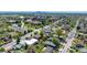 Aerial view of a neighborhood with mature trees, streets, and the Denver skyline in the background at 5242 Columbine Ln, Denver, CO 80221