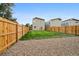 Spacious backyard with a privacy fence, gravel area and lush green grass at 5242 Columbine Ln, Denver, CO 80221