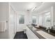 Bright bathroom features dual sinks, modern fixtures, and a glass shower at 5242 Columbine Ln, Denver, CO 80221