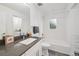 Bright bathroom with a tub, shower, large vanity and stone countertop at 5242 Columbine Ln, Denver, CO 80221