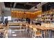 Inviting coffee shop interior with communal tables, a service counter, and a cozy ambiance at 5242 Columbine Ln, Denver, CO 80221