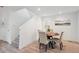 Bright dining area featuring a round wood table and seating for four, complemented by wood floors at 5242 Columbine Ln, Denver, CO 80221