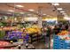 Inside a grocery store there are rows of colorful produce and the sign for the delicatessen is visible in the background at 5242 Columbine Ln, Denver, CO 80221