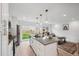 Bright kitchen with modern island, stainless steel appliances and a view into the living space at 5242 Columbine Ln, Denver, CO 80221
