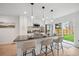 Bright kitchen features stainless appliances, sleek countertops, and a large island with bar seating at 5242 Columbine Ln, Denver, CO 80221