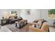 Cozy living room with neutral tones, plush seating, and ample natural light from a large window at 5242 Columbine Ln, Denver, CO 80221