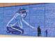 Public art wall featuring an expressive mural of a girl pointing to a Gathering, adds charm to area at 5242 Columbine Ln, Denver, CO 80221