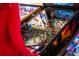 Close up on 2 pinball machines and the arm of the person playing, with colorful graphics and lighting at 5242 Columbine Ln, Denver, CO 80221