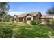 Well-maintained backyard with lush green lawn, mature trees, and covered patio area at 3380 Quail Ct, Wheat Ridge, CO 80033