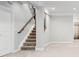 Finished basement area with staircase, neutral carpet, white trim, and potential for various uses at 3380 Quail Ct, Wheat Ridge, CO 80033