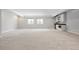 Large, carpeted basement area with two windows and a wet bar including a sink and microwave at 3380 Quail Ct, Wheat Ridge, CO 80033