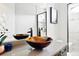 Modern bathroom featuring a vessel sink, updated mirror, and walk-in shower at 3380 Quail Ct, Wheat Ridge, CO 80033