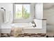Bright bathroom featuring a soaking tub, large window, and neutral tile work at 3380 Quail Ct, Wheat Ridge, CO 80033