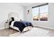 Bright bedroom with hardwood floors, a comfortable bed, and window views at 3380 Quail Ct, Wheat Ridge, CO 80033