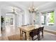 Bright dining room with hardwood floors and a view to the front yard at 3380 Quail Ct, Wheat Ridge, CO 80033