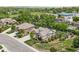 Elegant home featuring manicured lawn, lush landscaping, and mature trees in a sought-after neighborhood setting at 3380 Quail Ct, Wheat Ridge, CO 80033