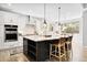 Stylish kitchen with an island, pendant lighting, stainless steel appliances, and lots of storage at 3380 Quail Ct, Wheat Ridge, CO 80033