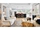 Open-concept living room features a sleek kitchen island, hardwood floors, and lots of natural light at 3380 Quail Ct, Wheat Ridge, CO 80033