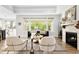 Bright living room featuring large windows, fireplace, and hardwood floors at 3380 Quail Ct, Wheat Ridge, CO 80033