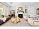 Cozy living room featuring a fireplace, modern furniture, and hardwood floors at 3380 Quail Ct, Wheat Ridge, CO 80033