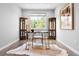 Well-lit home office with wood floors, built-in shelving, and large window at 3380 Quail Ct, Wheat Ridge, CO 80033